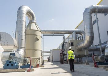 Project Manager walking outside of an energy power plant