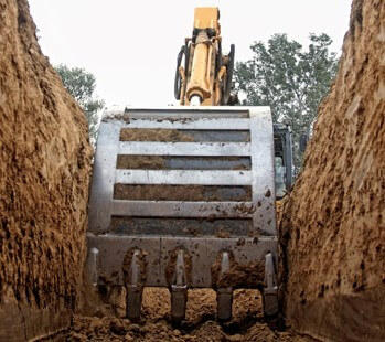 Large digger removing dirt on an excavation project